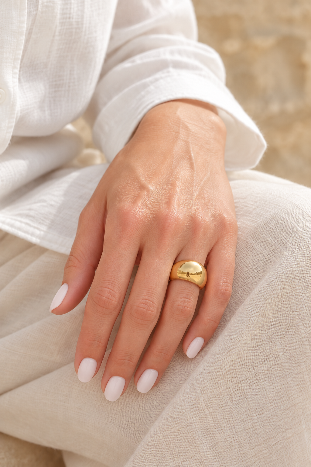 colina ring styled on hand with white manicure — digitally styled image