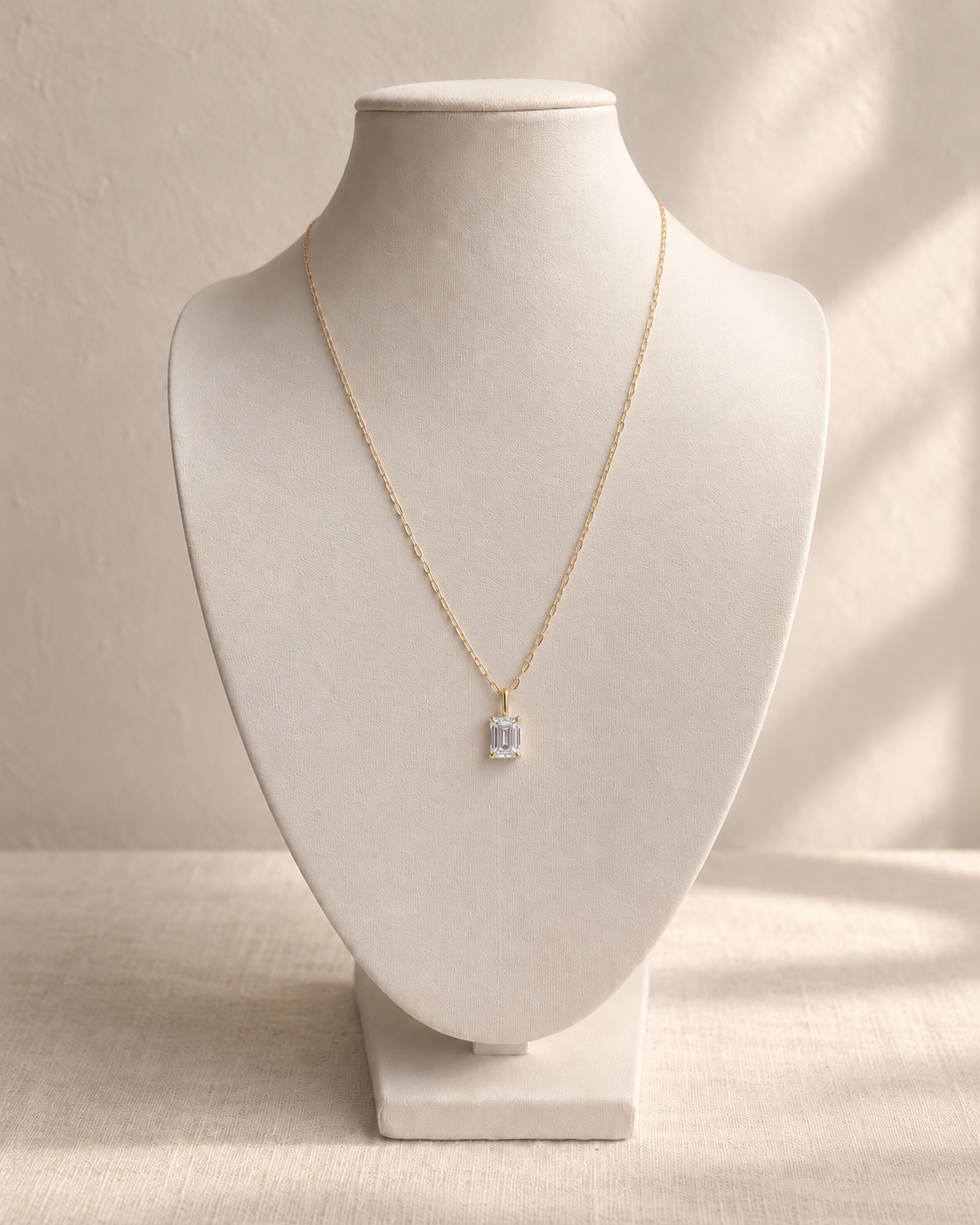 Clara Emerald-Cut Diamond Pendant Necklace — L’OURO styling on an ivory display bust