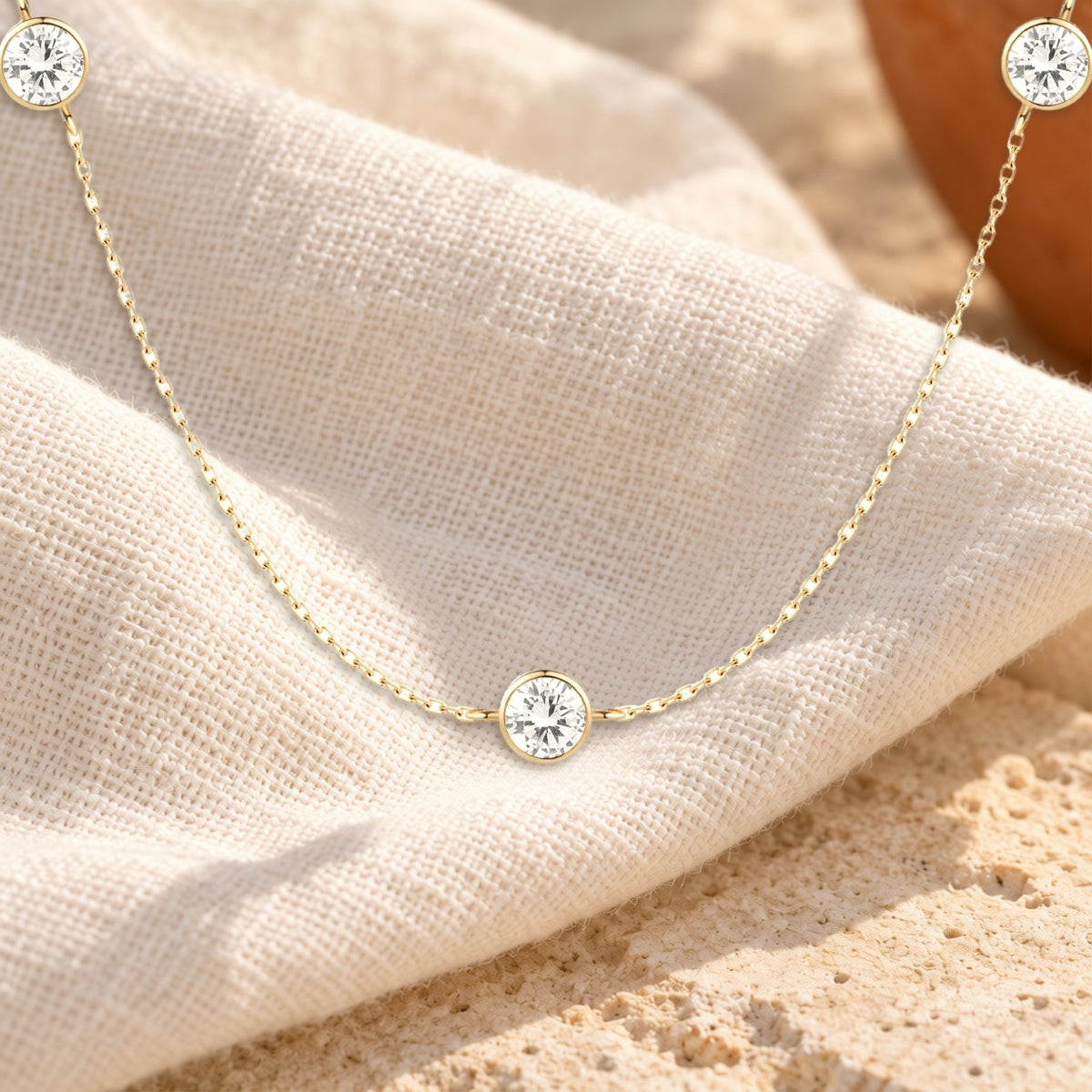 Pontos de Luz diamond station necklace on cream linen