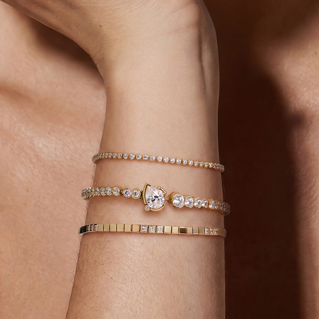 Gota pear-clasp bracelet shown in center; other bracelets styled separately