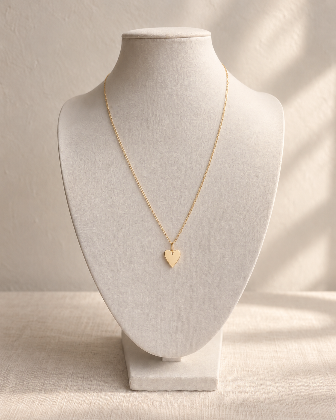 Amor 14K Heart Pendant Necklace — L’OURO styling on an ivory display bust