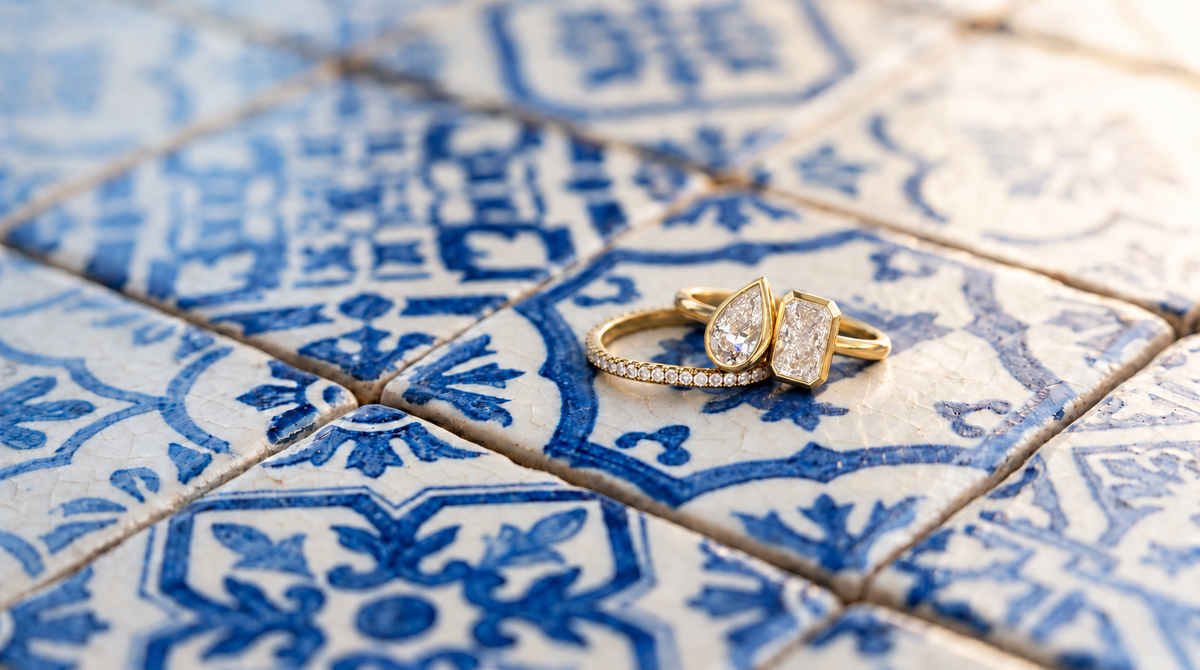 Andie's bezel ring stack styled on weathered blue and ivory azulejo tiles