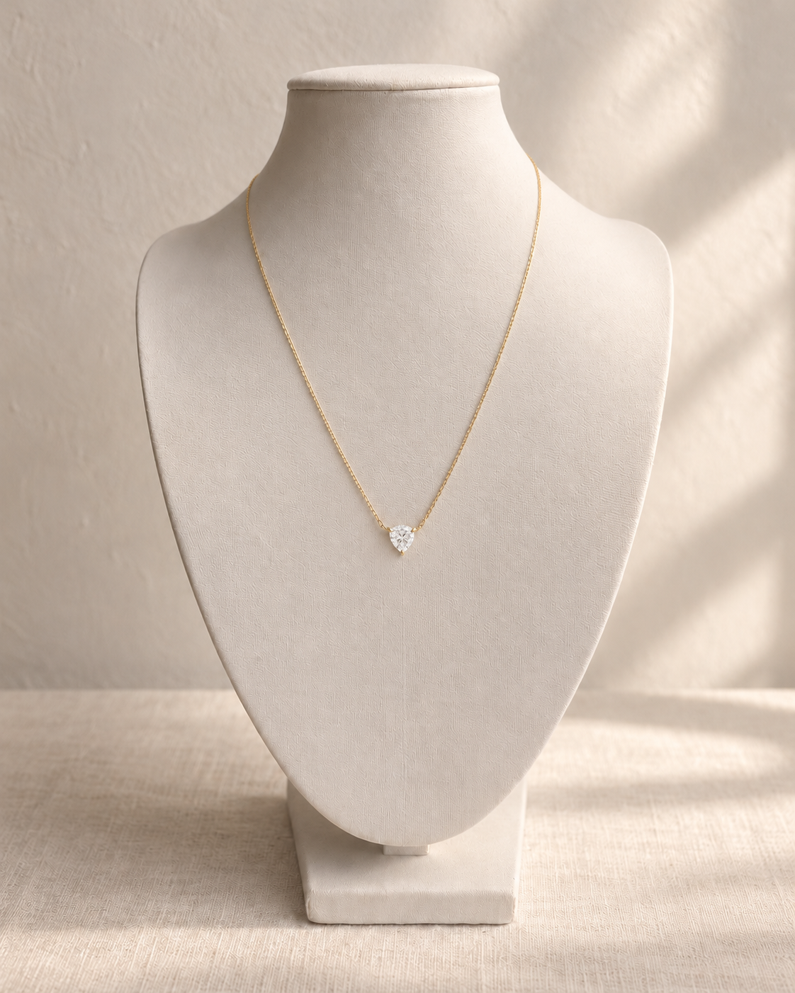 Beijo de Luz Pear Diamond Necklace — L’OURO styling on an ivory display bust