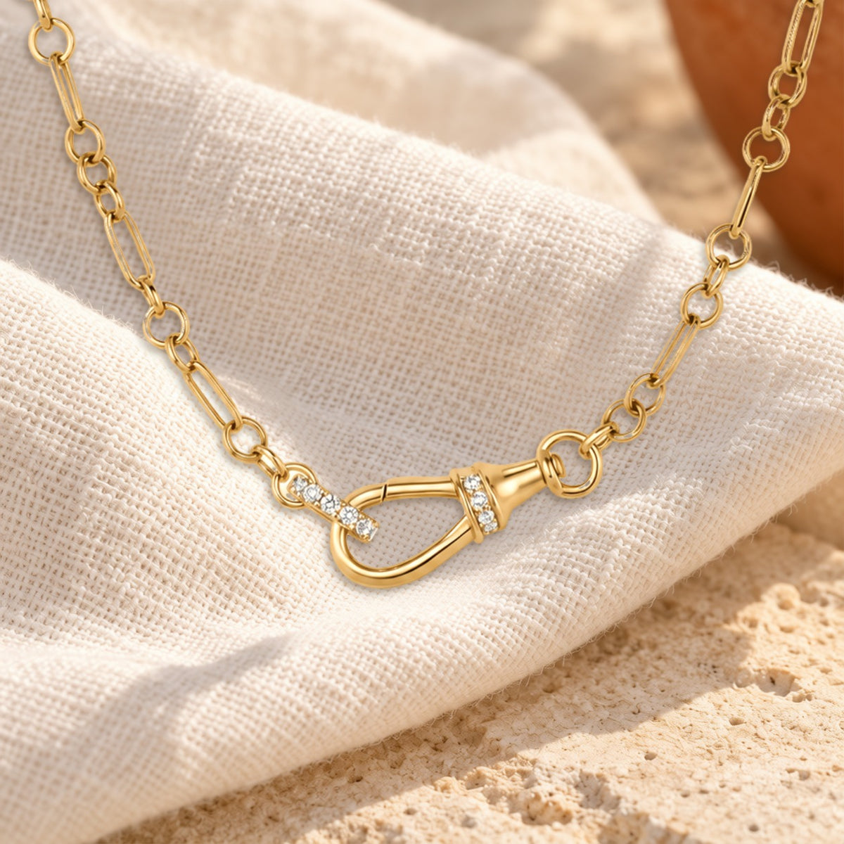 Enlace diamond charm holder necklace on cream linen