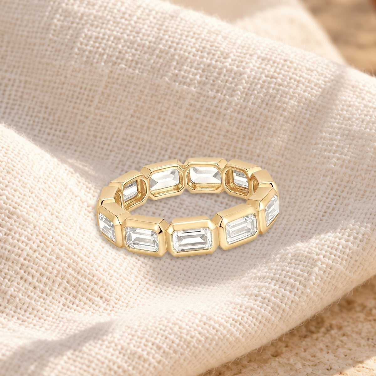 Mosaico emerald-cut bezel band on cream linen
