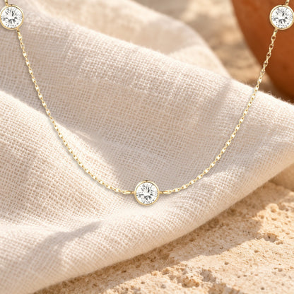 Pontos de Luz diamond station necklace on cream linen