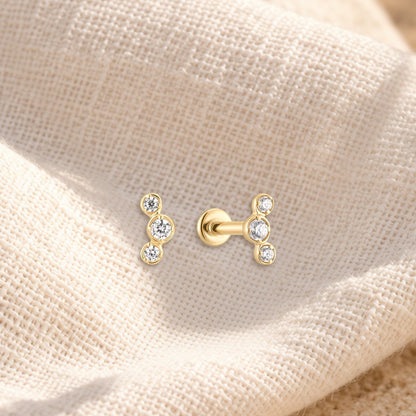 Três diamond flatback stud on cream linen