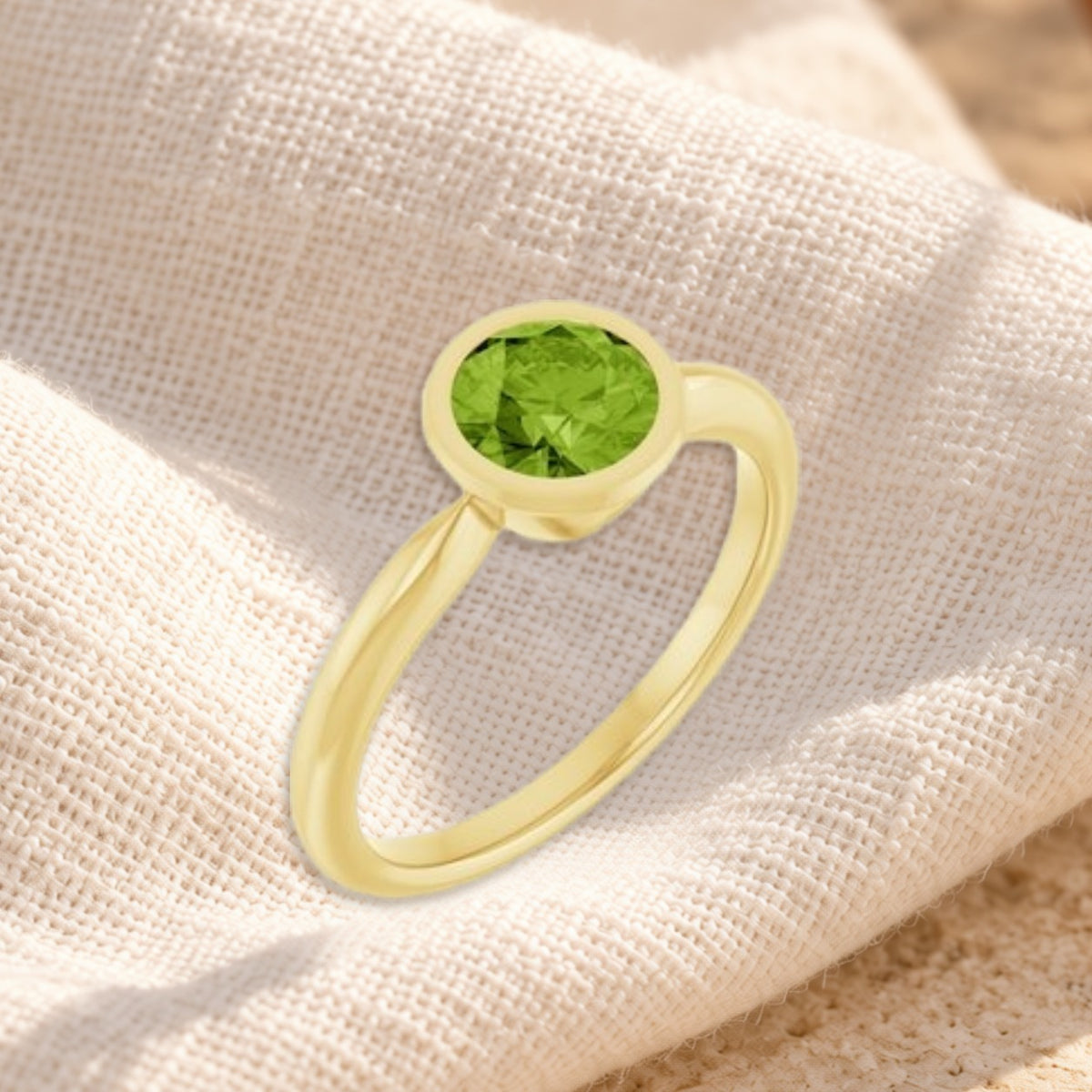 Verde peridot bezel ring on cream linen